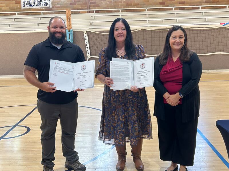 Levi Gotte (left) and Karen Lanehart (middle) are presented lifesaving awards by the American Red Cross at Parkview Christian Academy in Yorkville on Oct. 8, 2025. Laura Muriello (right) presented the awards.