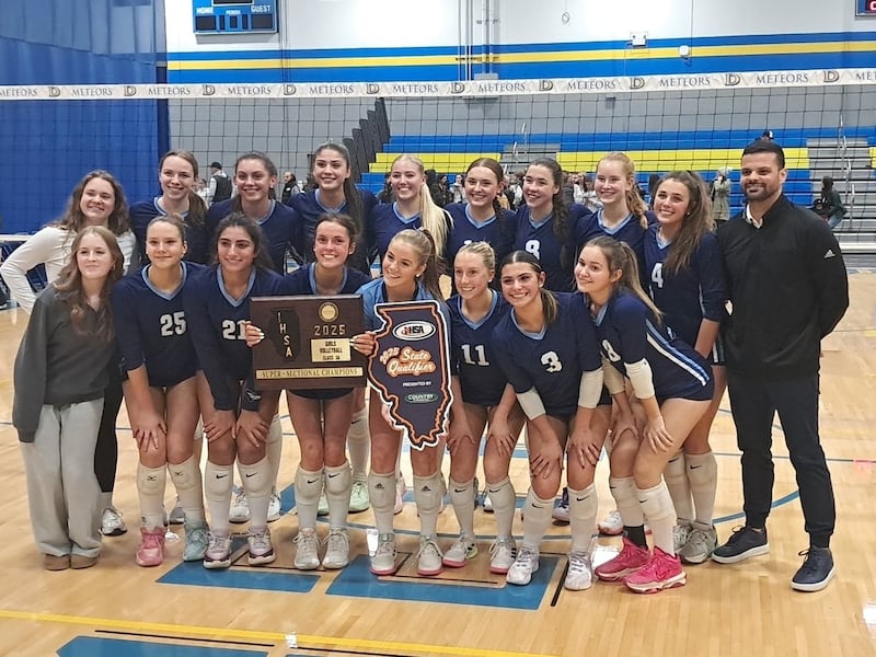 The Nazareth volleyball team poses with the supersectional plaque after beating Fenwick in the Class 3A De La Salle Supersectional.