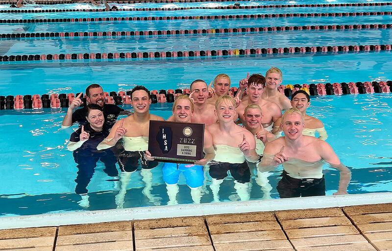 Sterling swimmers and coaches Kyle Ruiz (left rear) and Jamie Ruiz (left front) all jumped in the pool – with the sectional championship plaque in tow – after winning the team title in 2022 at the United Township Sectional in East Moline.