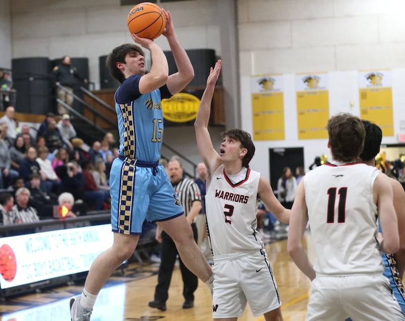 Marquette's Alec Novotney takes a jump shot over Woodland's Nolan Price during the Tri-County Conference Tournament championship on Friday, Jan. 30, 2026 at Putnam County High School.