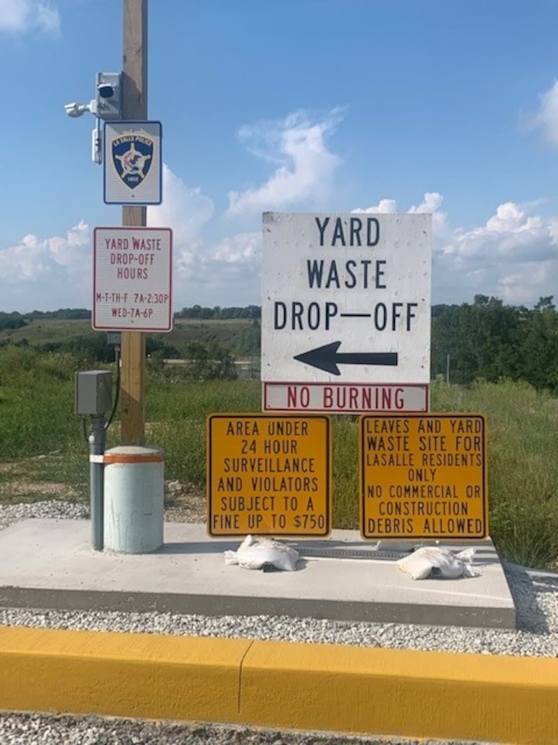 Signs advise residents the yard waste drop off facility in La Salle is monitored by video surveillance.