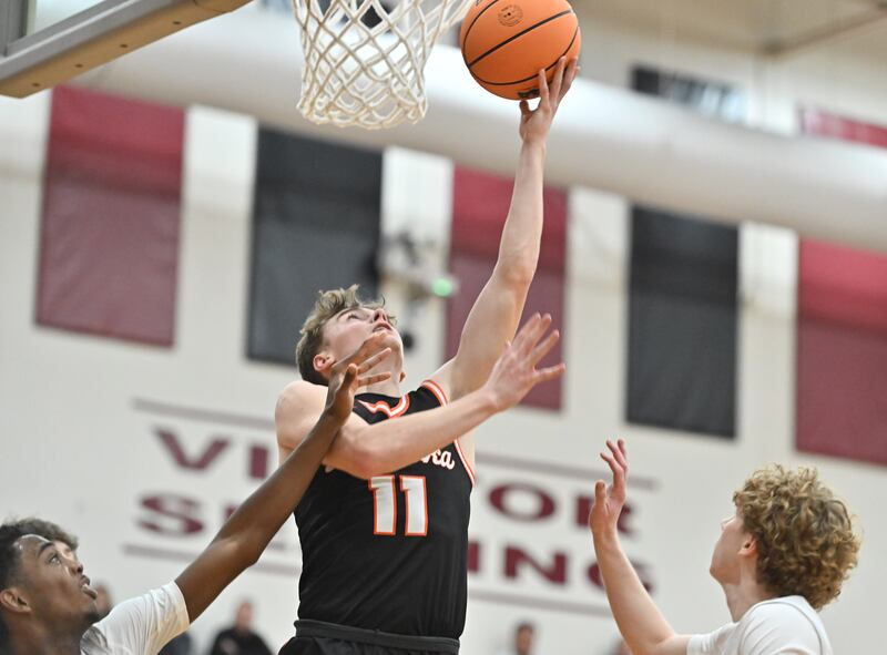 Minooka's Brady Hairald (11) goes up for a tough shot during the conference game against Plainfield North on Friday, JAN. 30, 2026, at Plainfield.