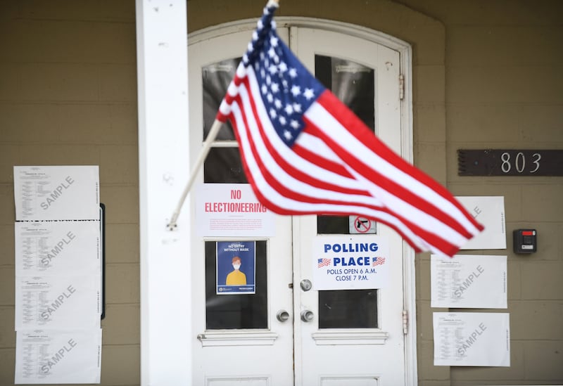 An American flag waves in front of a polling place during a 2021 election.
