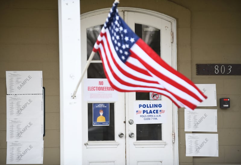 An American flag waves in front of a polling place during a 2021 election.