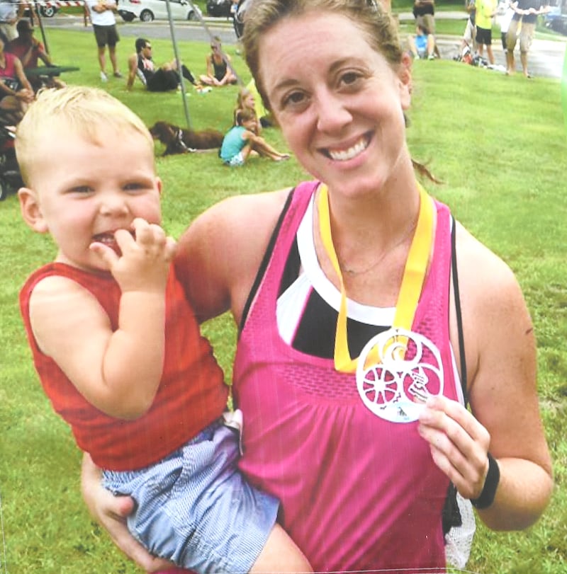 Maggie (Rosko) Meyer holds Amos after one of the races she competed in. The Infinity Run is held as a fundraiser for the Maggie & Amos Foundation in their memory.