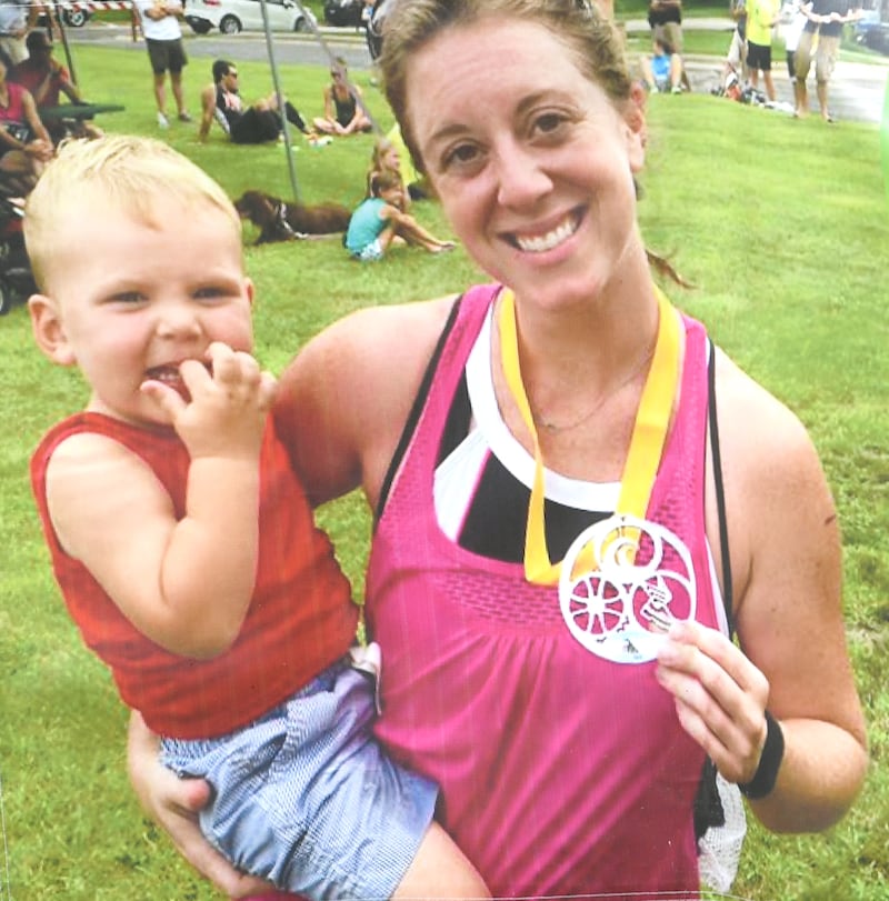 Maggie (Rosko) Meyer holds Amos after one of the races she competed in. The Infinity Run is held as a fundraiser for the Maggie & Amos Foundation in their memory.