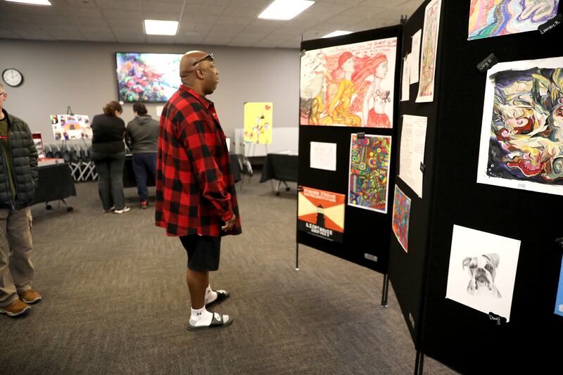 Terry Rogers looks at some of the artwork on display during an art show on Wednesday, April 16, 2025 at the Kane County Judicial Center in St. Charles. Participants in Kane County's four specialty courts – Adult Drug Court, DUI Court, Treatment Alternative Court and Veterans Court - had the opportunity to display their artwork.