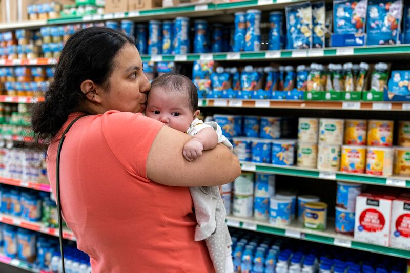 FILE - Yury Navas, 29, of Laurel, Md., kisses her two-month-old baby Jose Ismael Gálvez, at Superbest International Market in Laurel, Md., May 23, 2022, while looking for formula. (AP Photo/Jacquelyn Martin, file)