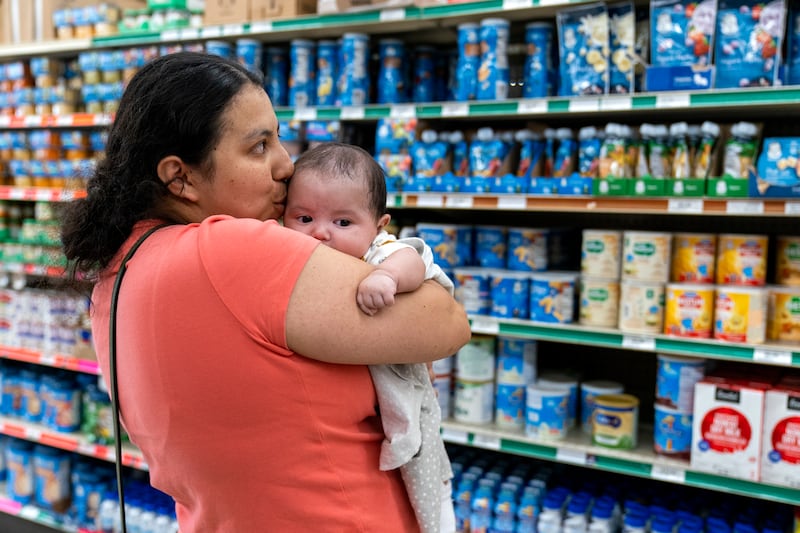 FILE - Yury Navas, 29, of Laurel, Md., kisses her two-month-old baby Jose Ismael Gálvez, at Superbest International Market in Laurel, Md., May 23, 2022, while looking for formula. (AP Photo/Jacquelyn Martin, file)