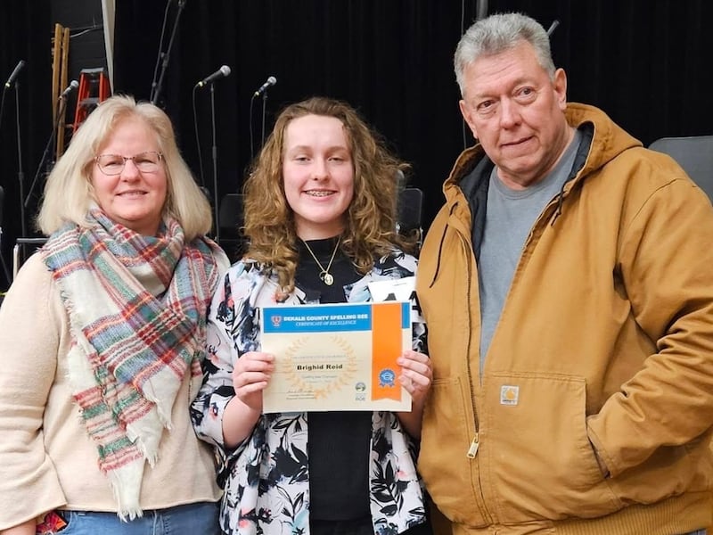 Brighid Reid stands with her mother, Pamela Reid, and her father, La Salle County Board member Jim Reid, R-District 4, after winning her second consecutive DeKalb County Regional Office of Education Spelling Bee on Feb. 21, 2026.