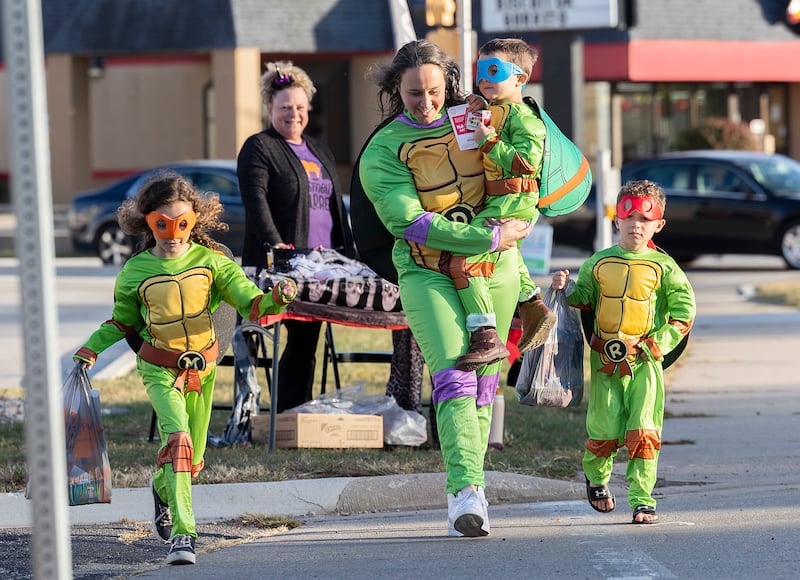 Dressed as the Teenage Mutant Ninja Turtles mom Rachel Hallstrom hits the Rock Falls downtown with her brood Kennedy (left), 7, McClain, 5, and Johan, 5, Friday, Oct. 25, 2024, for the Biz Boo Trick or Treat event.