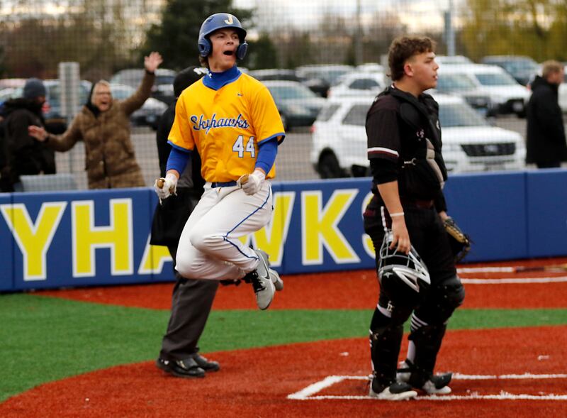 Johnsburg's Evan Pohl celebrates the game winning run after the infield umpire calls Marengo's Alexander Johnson for a bulk in the seven inning that allowed Pohl to score during a Kishwaukee River Conference baseball game on Monday, April 21, 2025, at Johnsburg High School.
