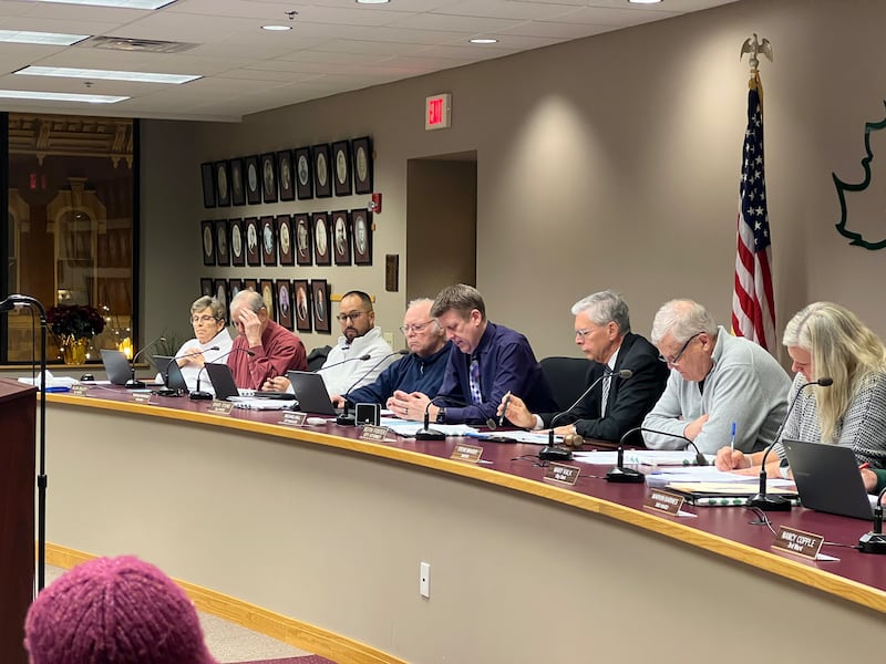 The Sycamore City Council – including 1st Ward Alderpersons Alicia Cosky and Alan Bauer, 2nd Ward Aldermen Mike Rodriguez and Chuck Stowe, Sycamore City Manager Michael Hall, City Attorney Keith Foster, Sycamore Mayor Steve Braser and City Clerk Mary Kalk – look over city documents during a Sycamore City Council meeting on Dec. 15, 2025.