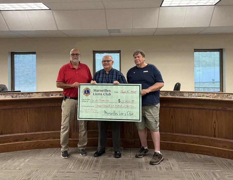 Marseilles Lions Club President Ralph Rowe and First Vice President Jim Hanlon present a $3,500 donation to Mayor Jim Hollenbeck during the City Council meeting Wednesday, completing the club’s $7,000 pledge toward the Broadway Park pavilion.