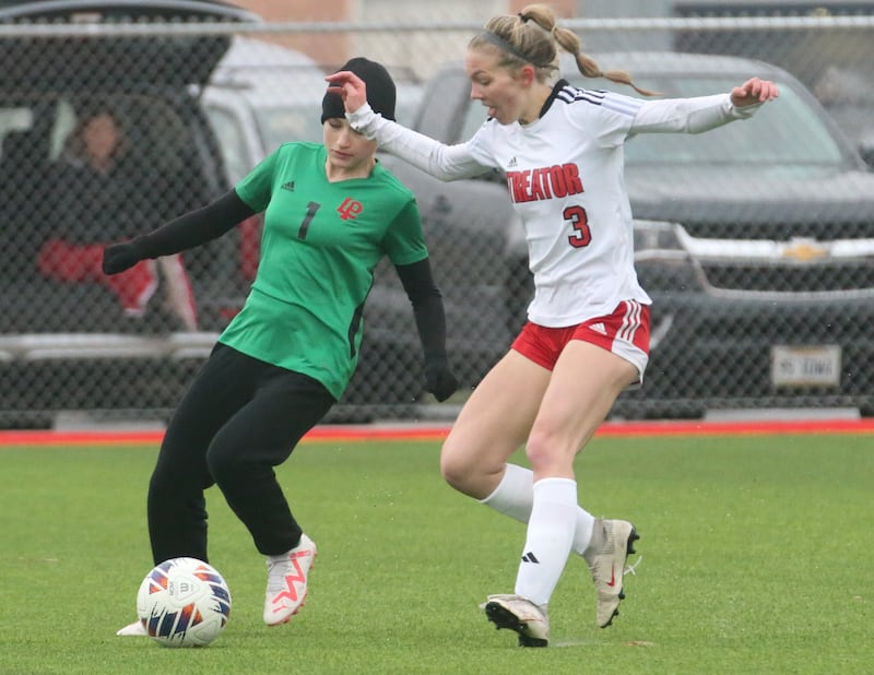 L-P's Addie Dawson pushes the ball away from Streator's Joey Puetz on Friday, March 22, 2024 at the L-P Athletic Complex in La Salle.
