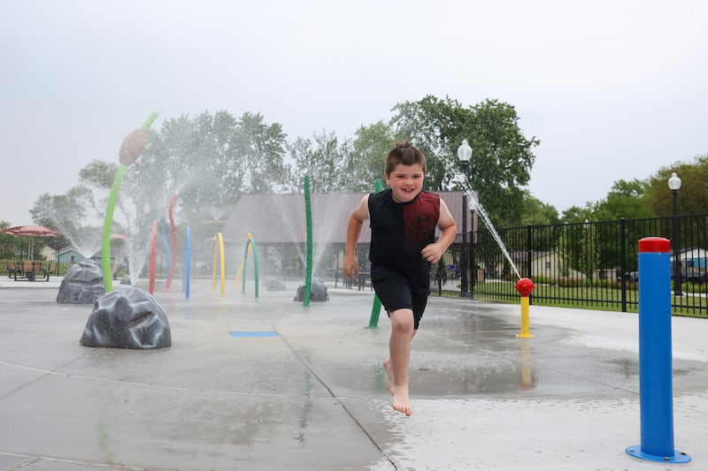 Rowan Mussa, 7, of Bradley, takes the first run through the new splash pad at Lil's Park in Bradley following the official ribbon-cutting on Friday, May 30, 2025.