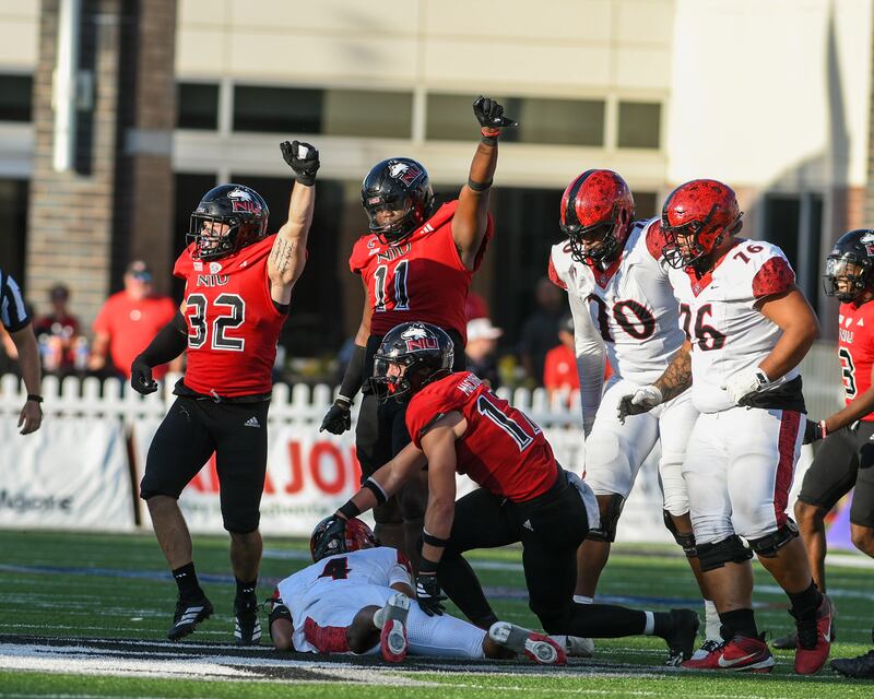 Northern Illinois University teammate’s linebacker Quinn Urwiler (32) and defensive end Jalonnie Williams (11) celebrate after bringing down San Diego State’s quarterback Jayden Denegal during the game on Saturday Sept. 27, 2025, held at Huskie Stadium in DeKalb.