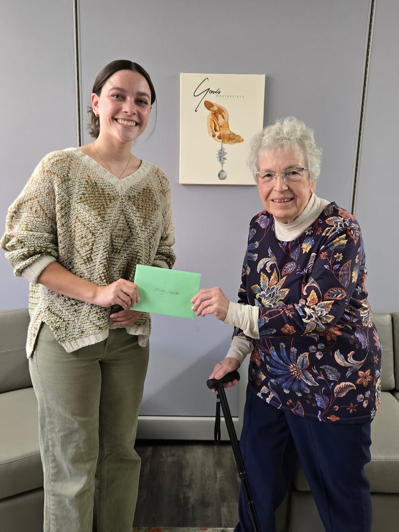 Ainsley Sasportas (left) accepts the scholarship from Marilyn Wilken, the Kankakee Art League's Scholarship Chairman.