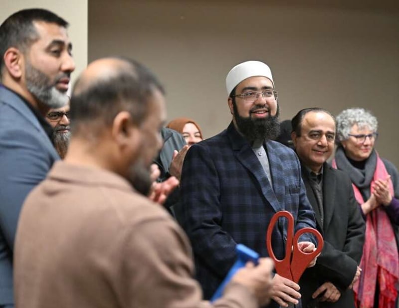 Mufti Yasir Nadeem, president of Burhan Academy, smiles after cutting a ceremonial ribbon at the school in Elgin Wednesday. The Islamic school opened on the former campus of Elgin Academy in the fall.
