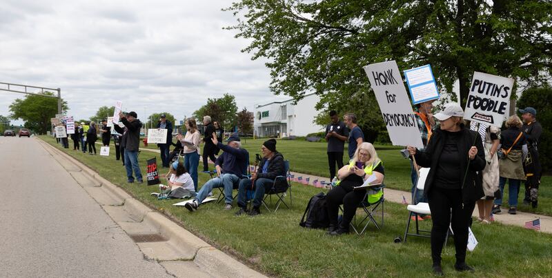 Protesters line a stretch of Ogden Avenue Sunday as part of the Hands Across Chicagoland demonstration, which stretched along Ogden Avenue from Aurora to Chicago