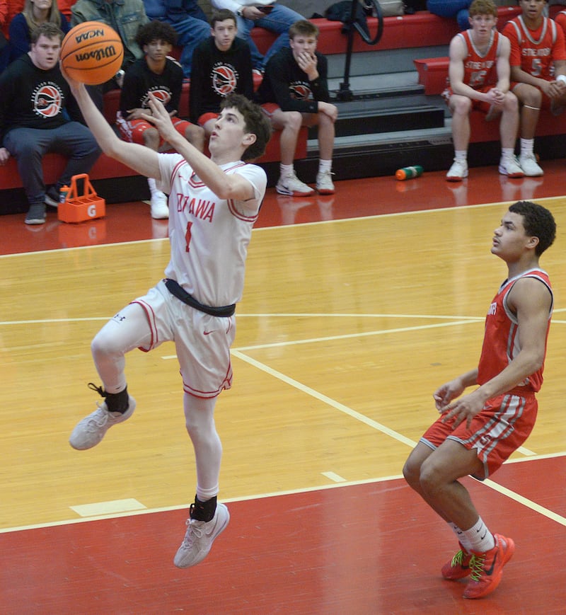 Ottawa’s Colt Bryson gets past Streator’s Layzeric Moton for a layup in the 2nd period Saturday at Ottawa.