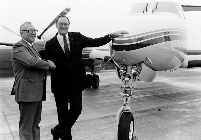 Former Illinois Gov. Jim Thompson and former Peru Mayor Don Baker shake hands next to a airplane during the grand opening of the Illinois Valley Regional Airport on Friday, Oct. 18, 1985 in Peru