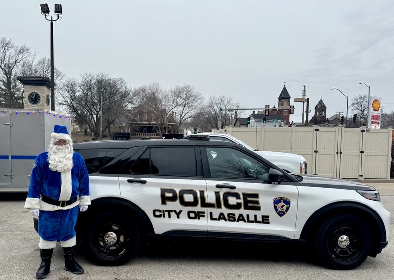 Officer Santa stands in front of a city of La Salle police cruiser on Saturday, December 14, 2024; ahead of delivering presents to more than 100 local children.