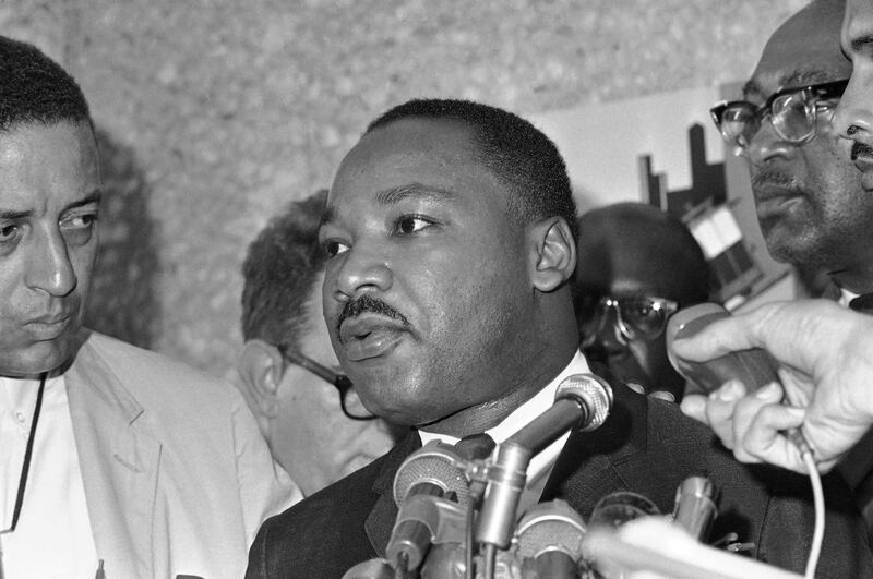 Dr. Martin Luther King addresses an airport press conference on arrival to launch a three-day civil rights campaign in Chicago, July 23, 1965.