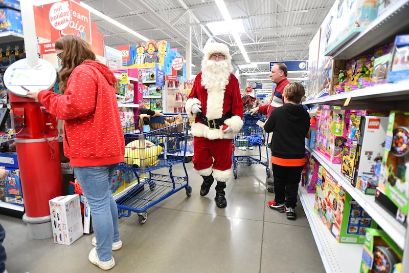 A volunteer dressed as Santa Claus roams the aisles as children shop for Christmas during the December 2023 shopping day at Meijer for the 28th Turkey for Tots, a longtime charity of the Kankakee Valley Beverage Association. The charity raised over $40,000 that year in order to help 400 area children in need shop for Christmas gifts.