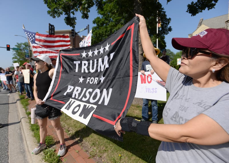 People including (left) Laura LaRocco of Burbank and Ana Godoy of LaGrange participate in the nationwide No Kings Day Rally held in LaGrange Saturday June 14, 2025.