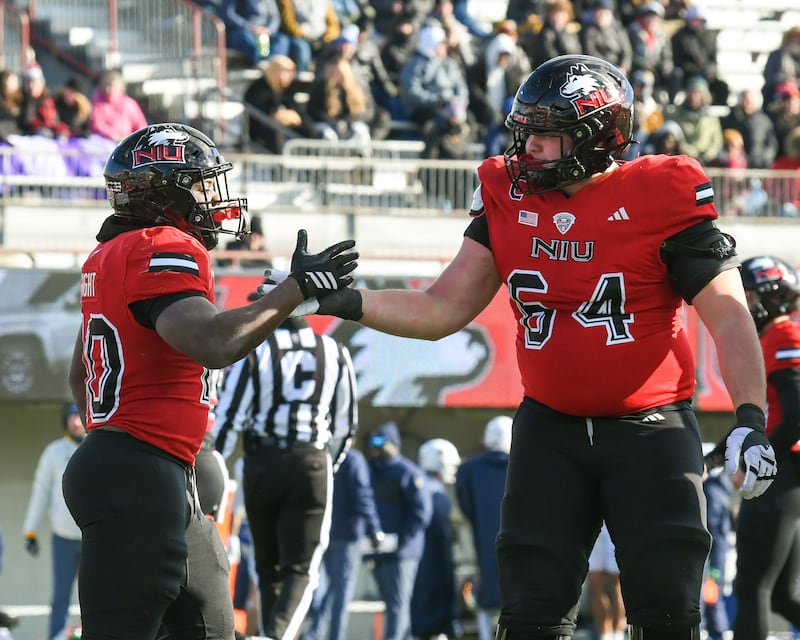 Northern Illinois University's running back Chavon Wright (10) celebrates with teammate Aidan Tweedy (64) after Chavon scored a touchdown during the game on Friday Nov. 28, 2025; while taking on Kent State held at Huskie Stadium in DeKalb.