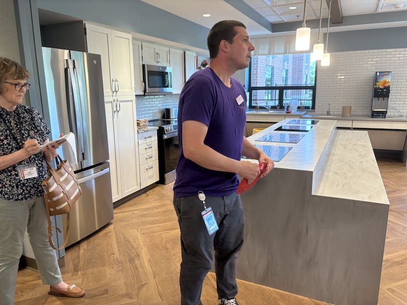 Valley Hi memory care director Nick Partridge holds a plate in the memory care wing in the nursing home June 23, 2025.
