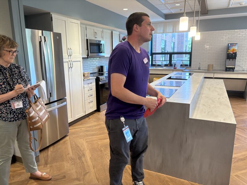 Valley Hi memory care director Nick Partridge holds a plate in the memory care wing in the nursing home June 23, 2025.