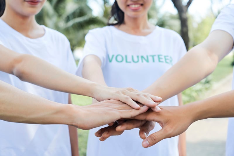Volunteers standing hands