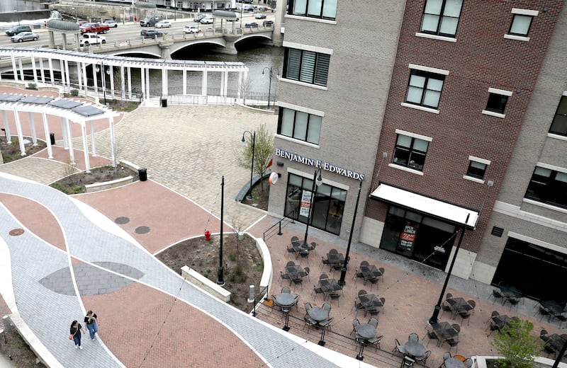 Pedestrians stroll in the closed section of First Street in St. Charles.