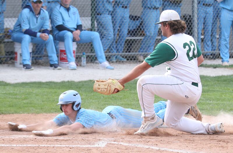 Marquette's Alec Novotney slides into home plate on a pass ball from St. Bede pitcher Alan Spencer on Monday, April 22, 2024 at St. Bede Academy.
