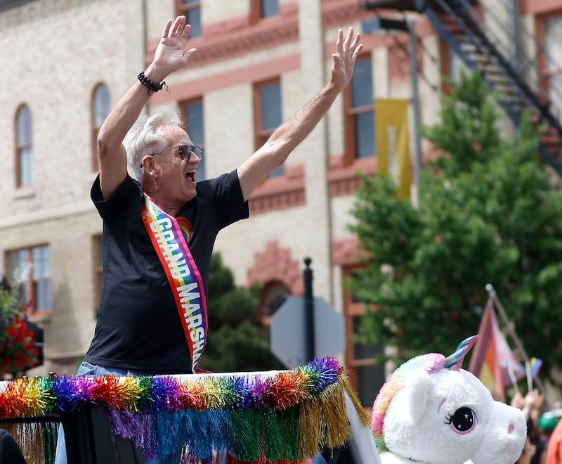 Grand Marshal Joe Weyland waves to the crowd during the Woodstock PrideFest Parade on Sunday, June 14, 2026, around the historic Woodstock Square, in Woodstock.