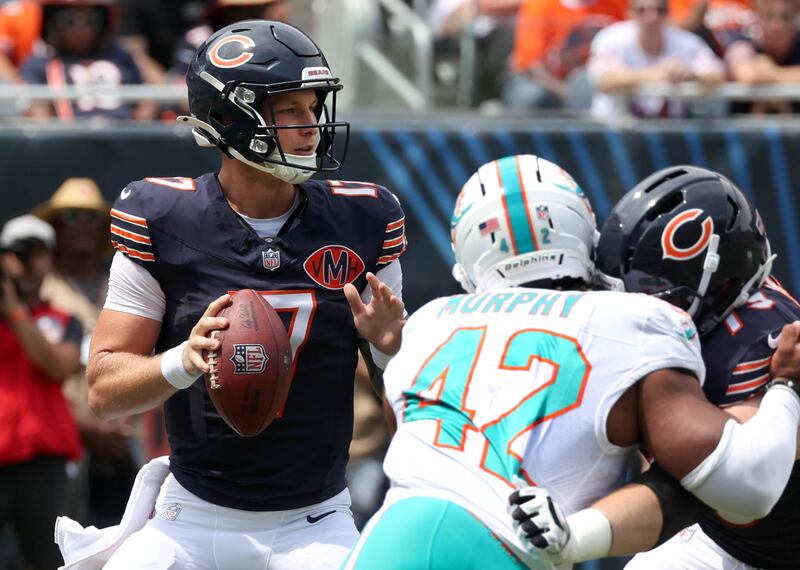 Chicago Bears quarterback Tyson Bagent looks for a receiver under the pressure of Miami Dolphins linebacker Grayson Murphy Sunday, Aug. 10, 2025, during their preseason game at Soldier Field in Chicago.