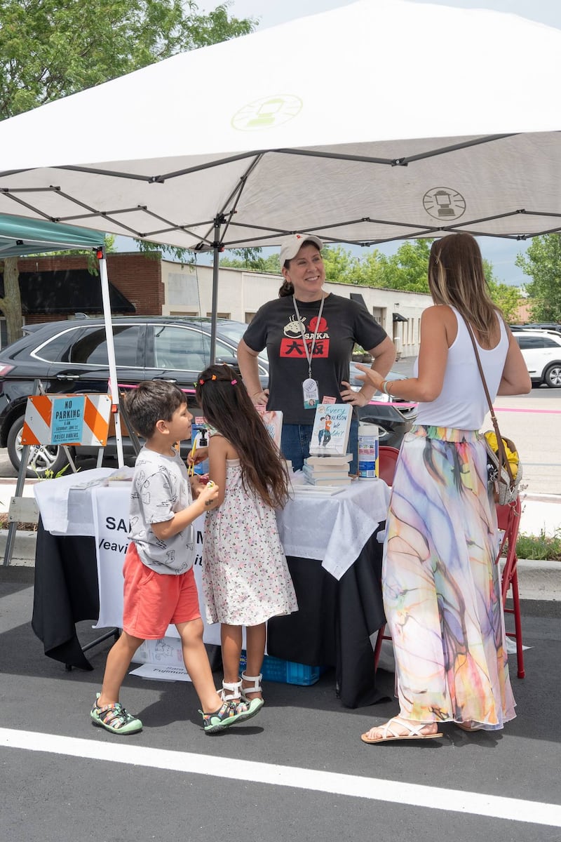 Author Sara Fujimura speaks with attendees at AuthorFest on June 22, 2024.