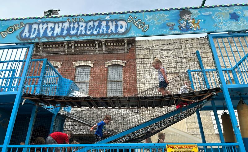 Jenna Martz, 2 1/2, of Polo, runs across the bridge on the Adventureland carnival ride during Town & Country Days on Saturday, June 15, 2024.