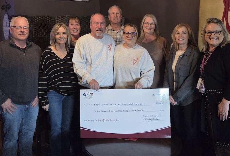 Members of the OHS/MHS Class of 1984 pose with a $7,500 donation check to the Natalie Claire Conrad Memorial Foundation at Valentino’s in Ottawa on Tuesday, March 25. From left to right: Chris Saar, Tracy Kistenfeger, Kathi Johnson, Dave Conrad, Rich Phelps, Jill Conrad, Kim Michelini, Jessica Haywood, and Carol Kuzmich.
