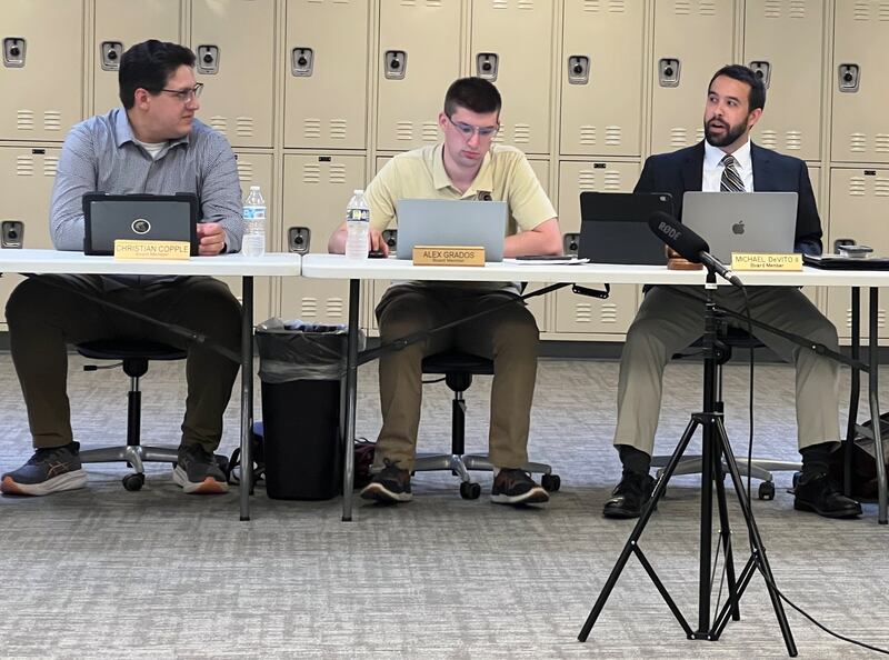 Sycamore Community School District board of education vice president Christian Copple looks across board member Alex. Grados as board president Michael DeVito speaks during a June 24, 2025 meeting.