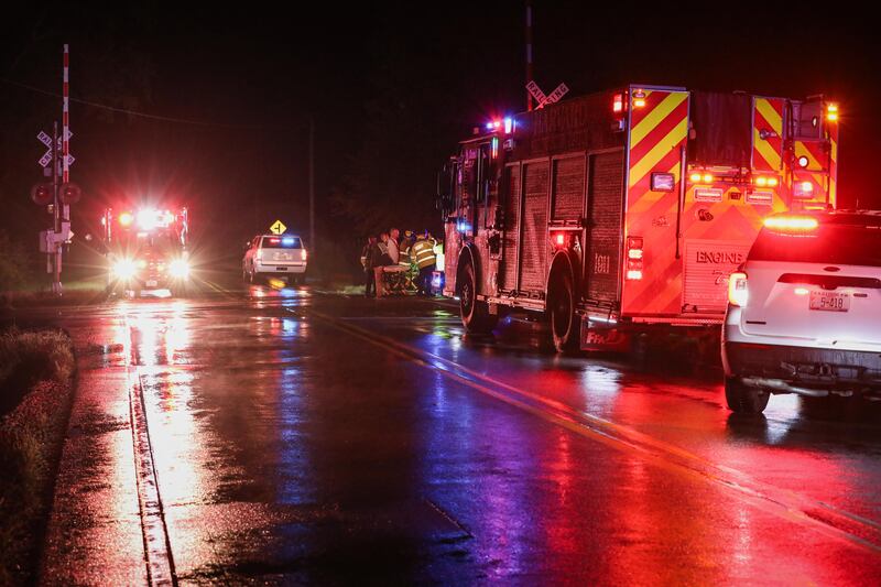 The Harvard Fire Protection District works a scene where a car was hit by a freight train and burst into flames early on Aug. 28, 2025.