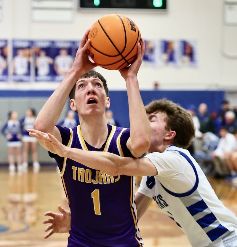 Mendota's Cole Tillman fights through the defense of Princeton's Jackson Mason for a second half Friday night at Prouty Gym. he scored 32 points, including his 1,000th career point, to lead the Trojans to an 80-54 win.