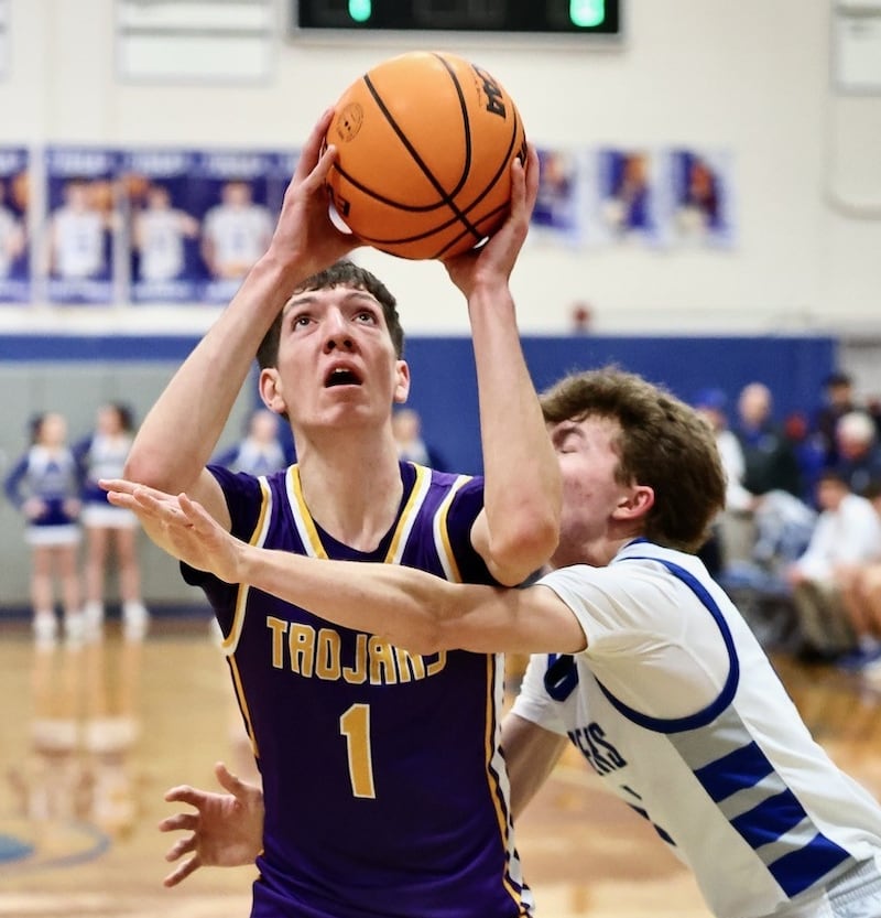 Mendota's Cole Tillman fights through the defense of Princeton's Jackson Mason for a second half Friday night at Prouty Gym. he scored 32 points, including his 1,000th career point, to lead the Trojans to an 80-54 win.