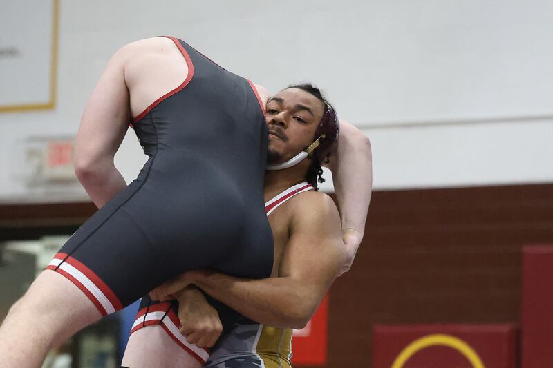 Morris’ Malachi Congo lifts Ottawa’s V Anderson in the 215 pound match on Wednesday, Dec. 10, 2025 in Morris.