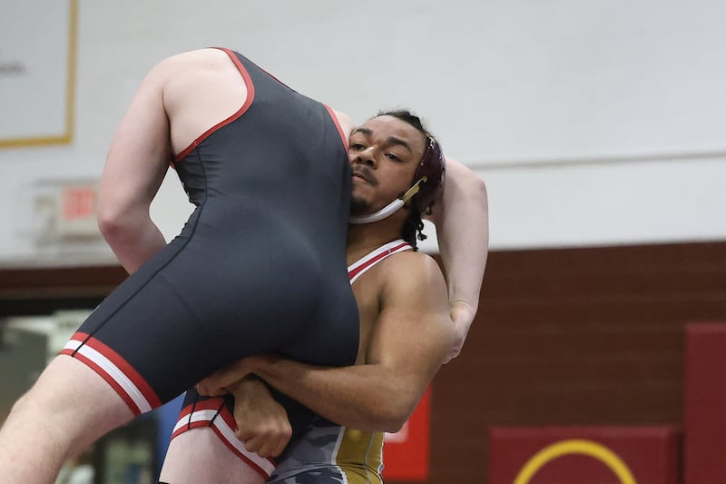 Morris’ Malachi Congo lifts Ottawa’s V Anderson in the 215 pound match on Wednesday, Dec. 10, 2025 in Morris.