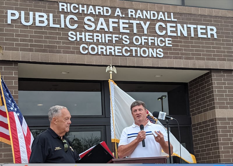 Kendall County Board Chairman Matt Kellogg, right, on Aug. 6 helped dedicate the Kendall County Public Safety Center to former Kendall County sheriff Richard Randall, left, on Aug. 6, 2024.