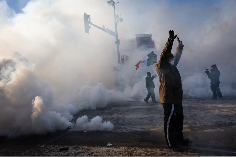 A person holds up their hands as law enforcement deploys a thick screen of teargas on Nicollet Avenue in Minneapolis on Saturday, Jan. 24, 2026. (Ben Hovland/Minnesota Public Radio via AP)