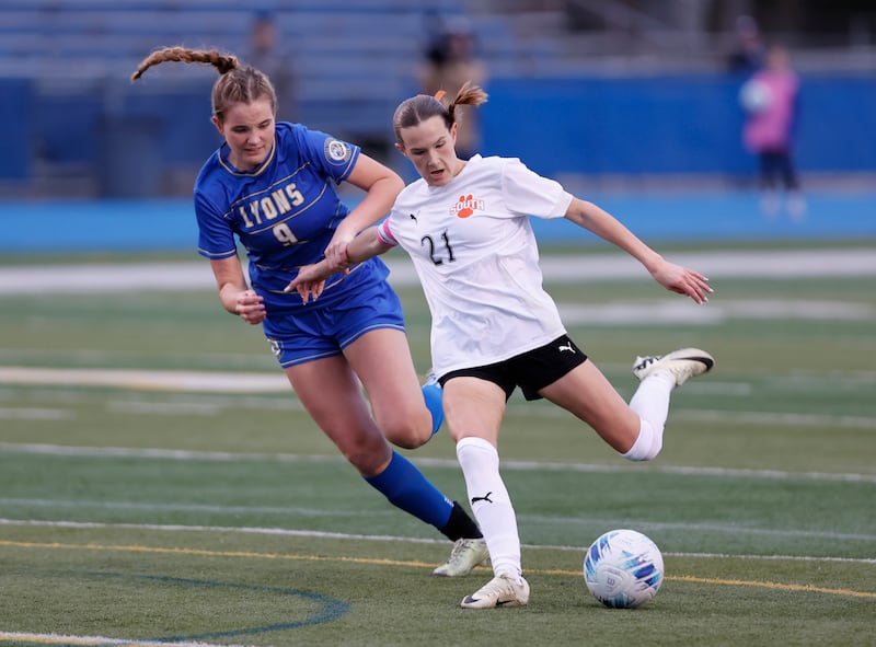 Wheaton Warrenville South's Ashlyn Adams (21) takes a shot on goal and scores during the girl's varsity soccer match between Lyons Township and Wheaton Warrenville South high schools on Thursday, March 27, 2025 in Western Springs.